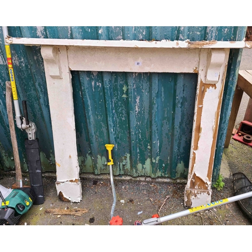 27 - A pine fire surround with remains of painted white finish