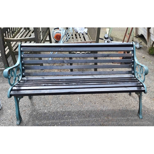 3 - A Victorian garden bench with decorative cast iron ends and slatted wood seat and backrest