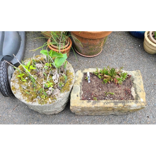 39 - An old stone trough planter and a decorative stone garden pot - both with weathered patina