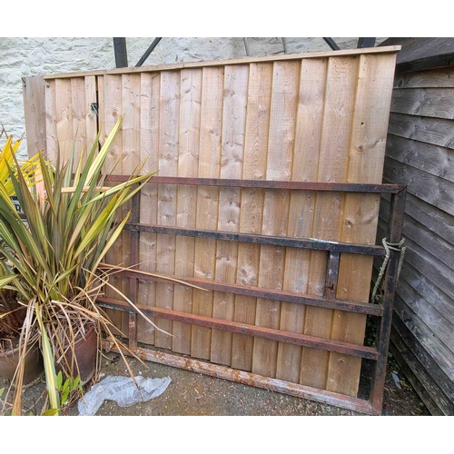 41 - A pair of large panelled wood gates fitted with cast iron strap hinges - each 1.75m high X 1.98m wid... 