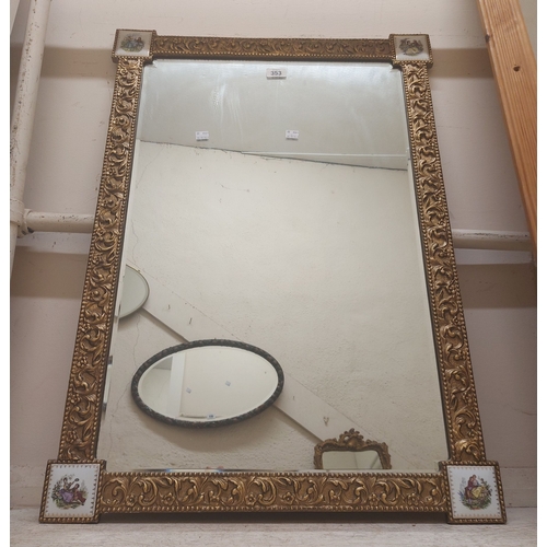 353 - A large Reflectwell gilt framed bevelled oblong wall mirror with printed porcelain panels to corners
