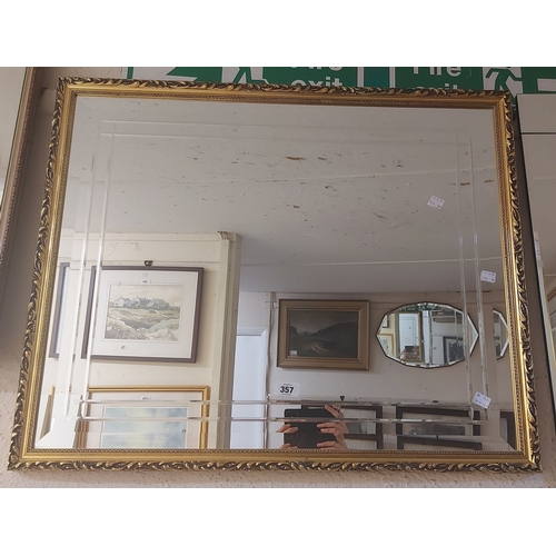 357 - A large gilt framed bevelled oblong wall mirror with cut border