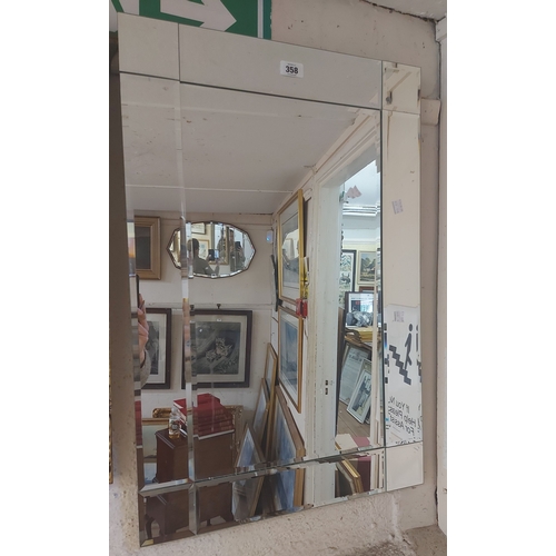 358 - A modern frameless oblong wall mirror with multiple bevelled plates