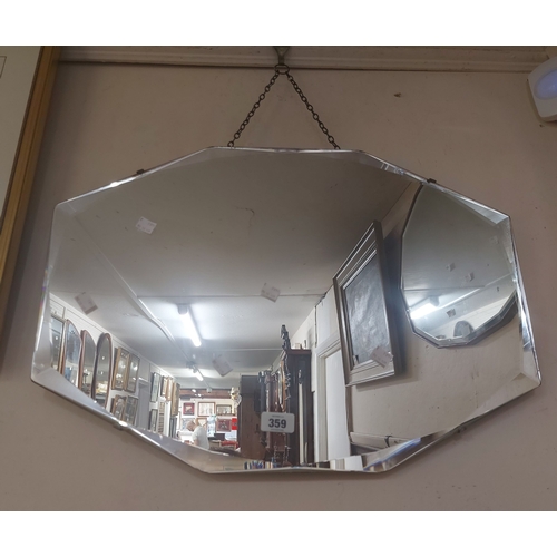 359 - A vintage frameless wall mirror with shaped bevelled plate