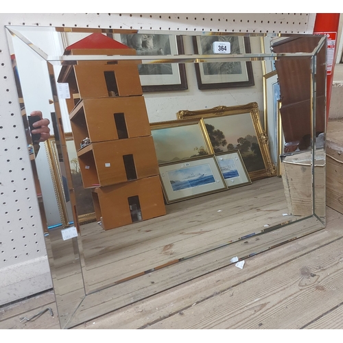 364 - A modern frameless wall mirror with multiple bevelled plates
