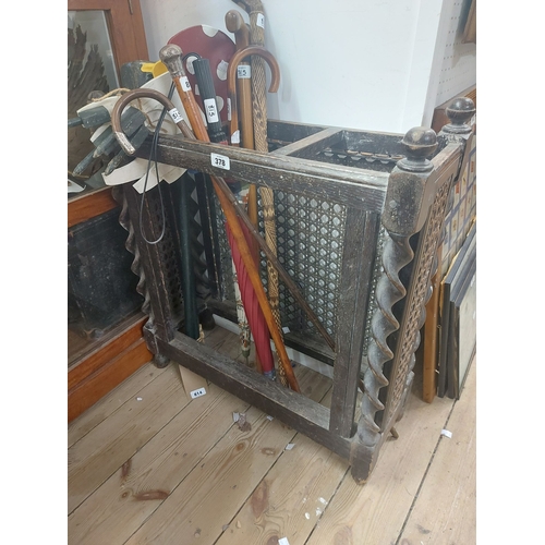 378 - A 66cm early 20th Century oak stick stand with rattan panelled sides and barley twist supports - no ... 