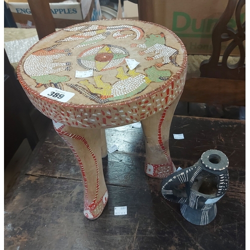 389 - An African hardwood stool with inset beadwork decoration depicting animals - sold with an African la... 
