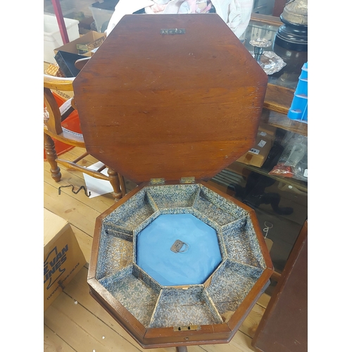 394 - A 44cm Victorian walnut trumpet worktable with inlaid octagonal top and fitted interior, set on turn... 