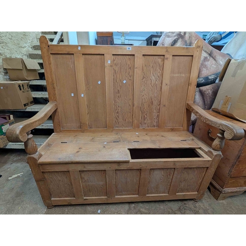 305 - A 1.4m antique pine settle with panelled back and double locker seat, set on bun feet - one seat lid... 
