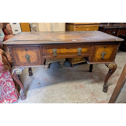 307 - A 1.23m early 20th Century walnut kneehole desk with brown leather inset top, three frieze drawers a... 