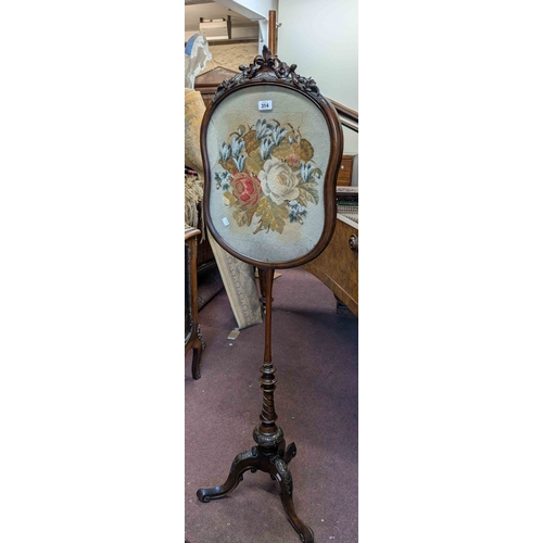 314 - A Victorian mahogany pole screen with beadwork tapestry panel depicting flowers under glass, set on ... 