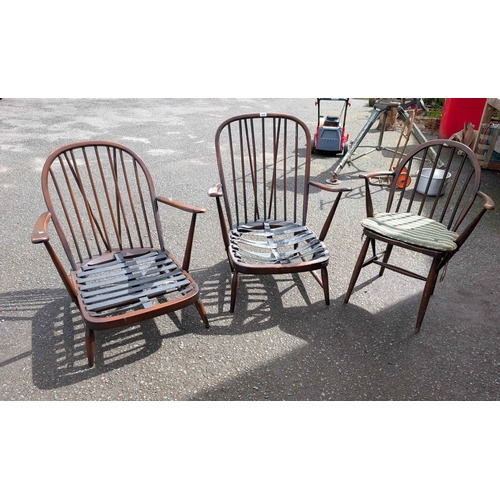 319 - An Ercol dark elm hoop stick back low armchair - sold with another similar and an Ercol hoop stick b... 