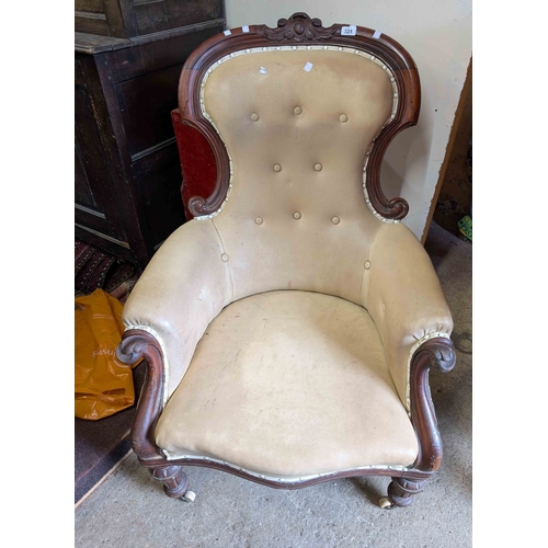 324 - A Victorian carved mahogany part show frame spoonback armchair with button back upholstery, set on t... 