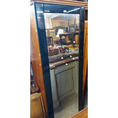 361 - A modern full-length wall mirror with bevelled plate and black border - 1.84m X 66cm