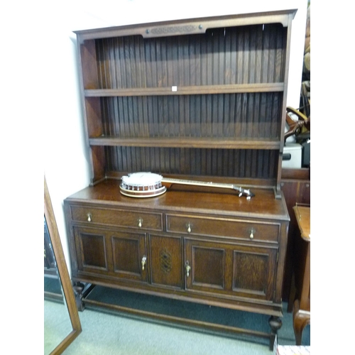 294 - Large Edwardian Oak carved dresser with panel back over drawer and cupboard base