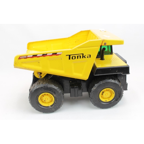 54 - 3 Large Yellow Tonka Trucks and a Smaller Tonka Crane