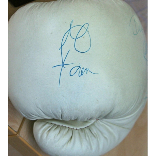 83 - A full size Title boxing glove personally signed by George Foreman and a young Nigel Benn who signs ... 