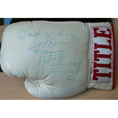 83 - A full size Title boxing glove personally signed by George Foreman and a young Nigel Benn who signs ... 