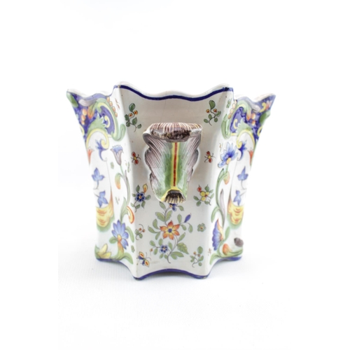 38 - French Rouen Faience Jardiniere with brightly coloured floral decoration and a table candlestick