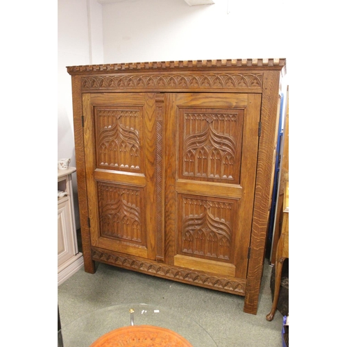 367 - Heavy Handmade Oak hall cupboard with carved ecclesiastical panelled doors, 3 shelves to interior