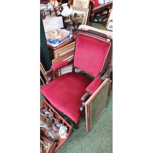 425 - Ornately carved wooden lounge chair with upholstered arms back and seat.