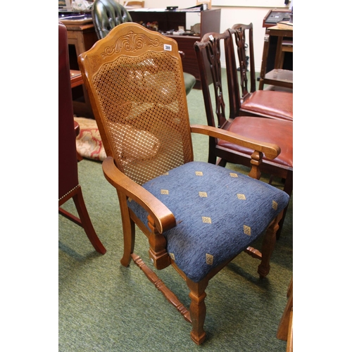 308 - Light oak rattan backed carver chair with blue upholstered seat.