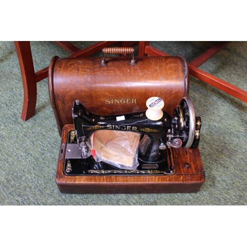 174a - Cased singer sewing machine with manual and key