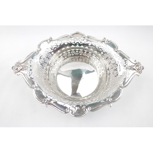 158 - Fine Edwardian Silver Pierced fruit bowl of Diamond form with figural handles supported on scroll fe... 