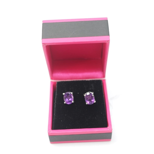 301 - Pair of Silver Oval Amethyst set stud earrings