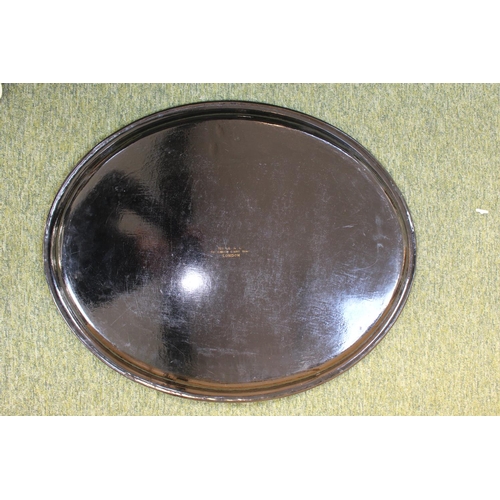 76 - Lacquer Papier-mâché tray of Oval form stamped Maple & Co, Tottenham Court Road London 68cm in Diame... 