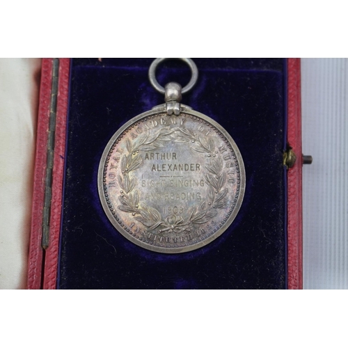 182 - 2 Cased John Pinches Medallist of London Silver Royal Academy of Music White metal medal and a Gilt ... 