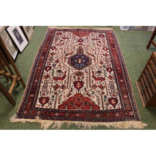 557 - Red Ground Persian machine made rug with tassel ends 185 x 122cm