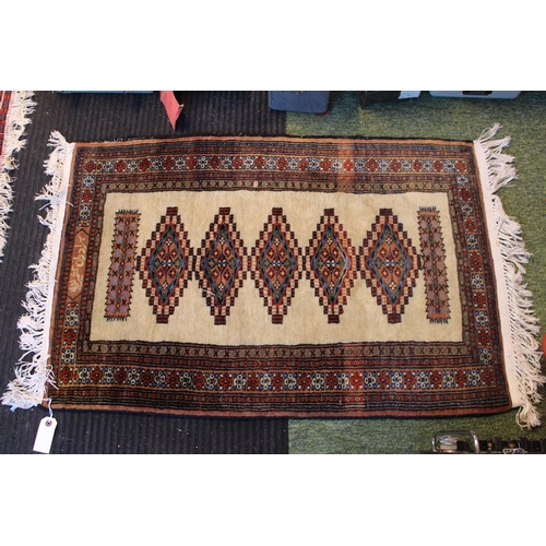 563 - Cream Ground rug with floral border 105 x 64cm