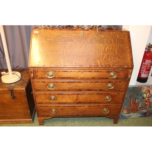 569 - George III Oak fall front bureau with oval brass handles supported on bracket feet