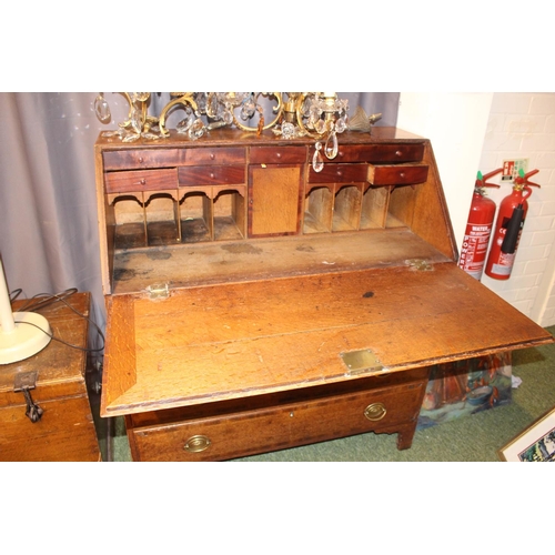 569 - George III Oak fall front bureau with oval brass handles supported on bracket feet