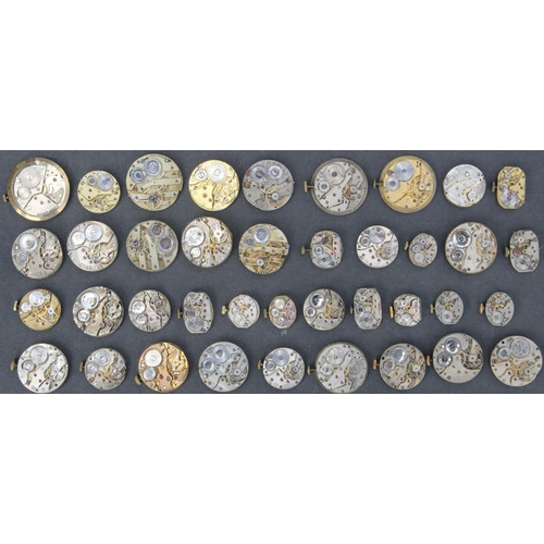 232j - Collection of 39 Watch Movements & Faces inc Trojan, Omega & Eros. Watch movements inc Trojan, Thoma... 