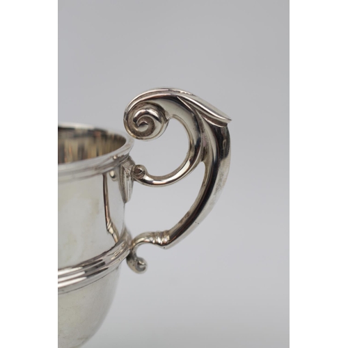 101 - Heavy gauge Silver Trophy with double scroll handle by West & Son of Dublin 1897. 140g total weight