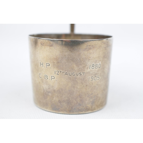 139 - A Silver cup holder with loop handle London1909 by The Goldsmiths & Silversmiths Company. 77g total ... 