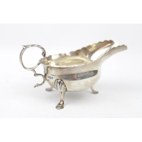 143 - A Silver Georgian-style cream boat, the base inset with a silver sixpence dated 1745 12cm long, Shef... 