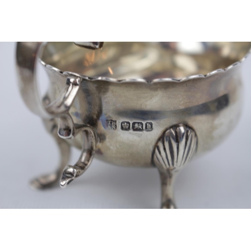 143 - A Silver Georgian-style cream boat, the base inset with a silver sixpence dated 1745 12cm long, Shef... 