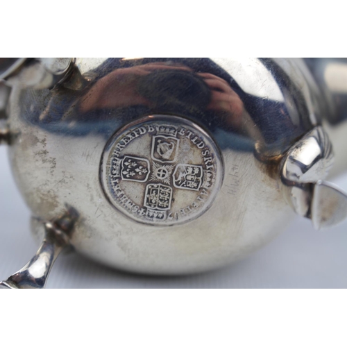 143 - A Silver Georgian-style cream boat, the base inset with a silver sixpence dated 1745 12cm long, Shef... 