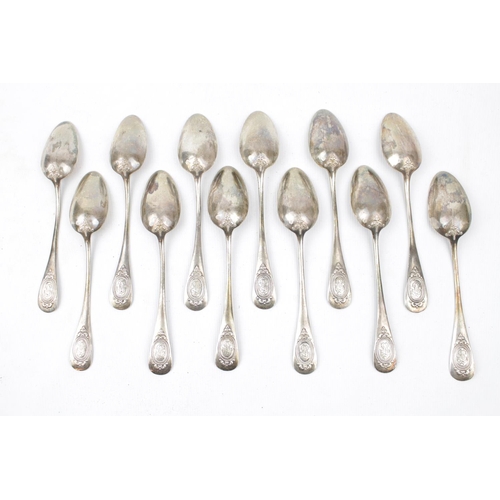 144 - A set of 12 Silver French small dessert spoons with applied decoration - 295g total weight