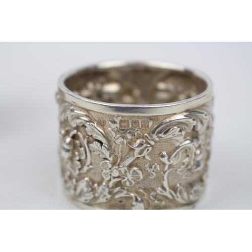 156 - A Good pair of heavy chased silver napkin rings, London 1896 by Edward Barnard & Sons Ltd. 105g tota... 