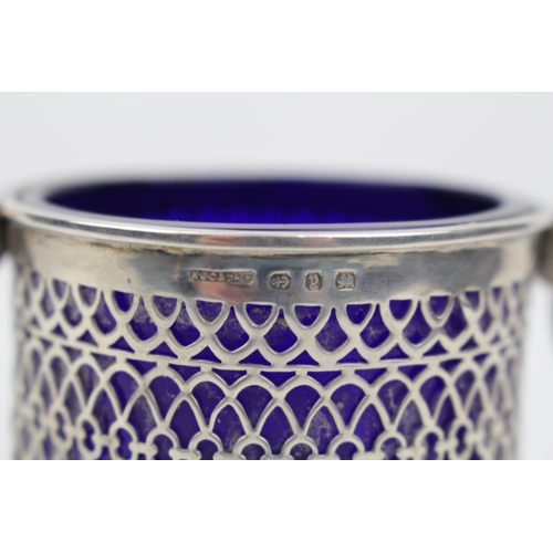 182 - A Silver circular bowl with pierced side and blue glass liner on three pad feet, 7cm in Height, Birm... 