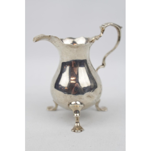 185 - 18thC Cream jug with leaf capped handle - London possibly 1749. 67g total weight