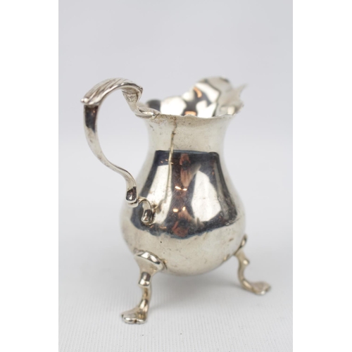 185 - 18thC Cream jug with leaf capped handle - London possibly 1749. 67g total weight