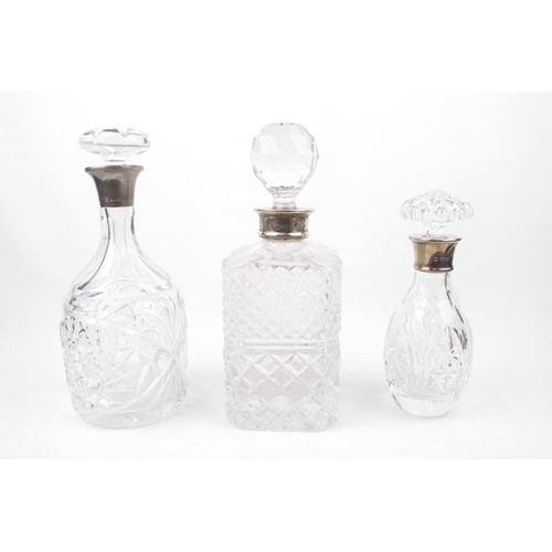 233 - 3 20thC Decanters with Silver collars with stoppers ranging from 26cm to 20cm