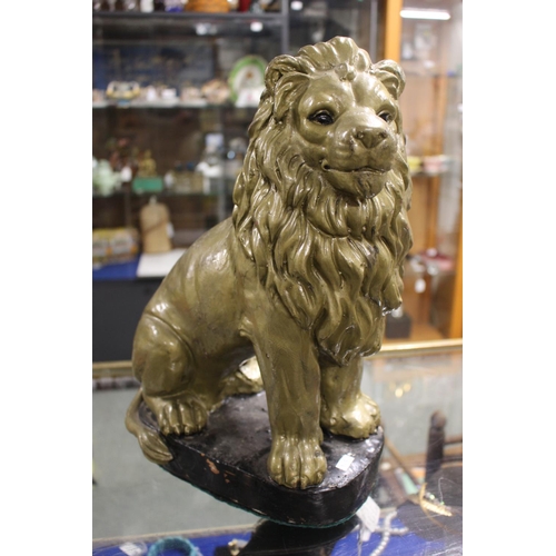 167 - Pottery cast figure of a Lion, gold painted on black base, 40cm in Height