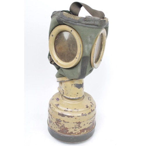 139 - A WWII German gas mask stamped FE42, in original case with integral compartment and a JB/42 Gas Mask... 