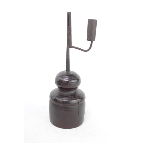 59 - An 18th century wrought iron rush light, with turned wooden base 25cm in height